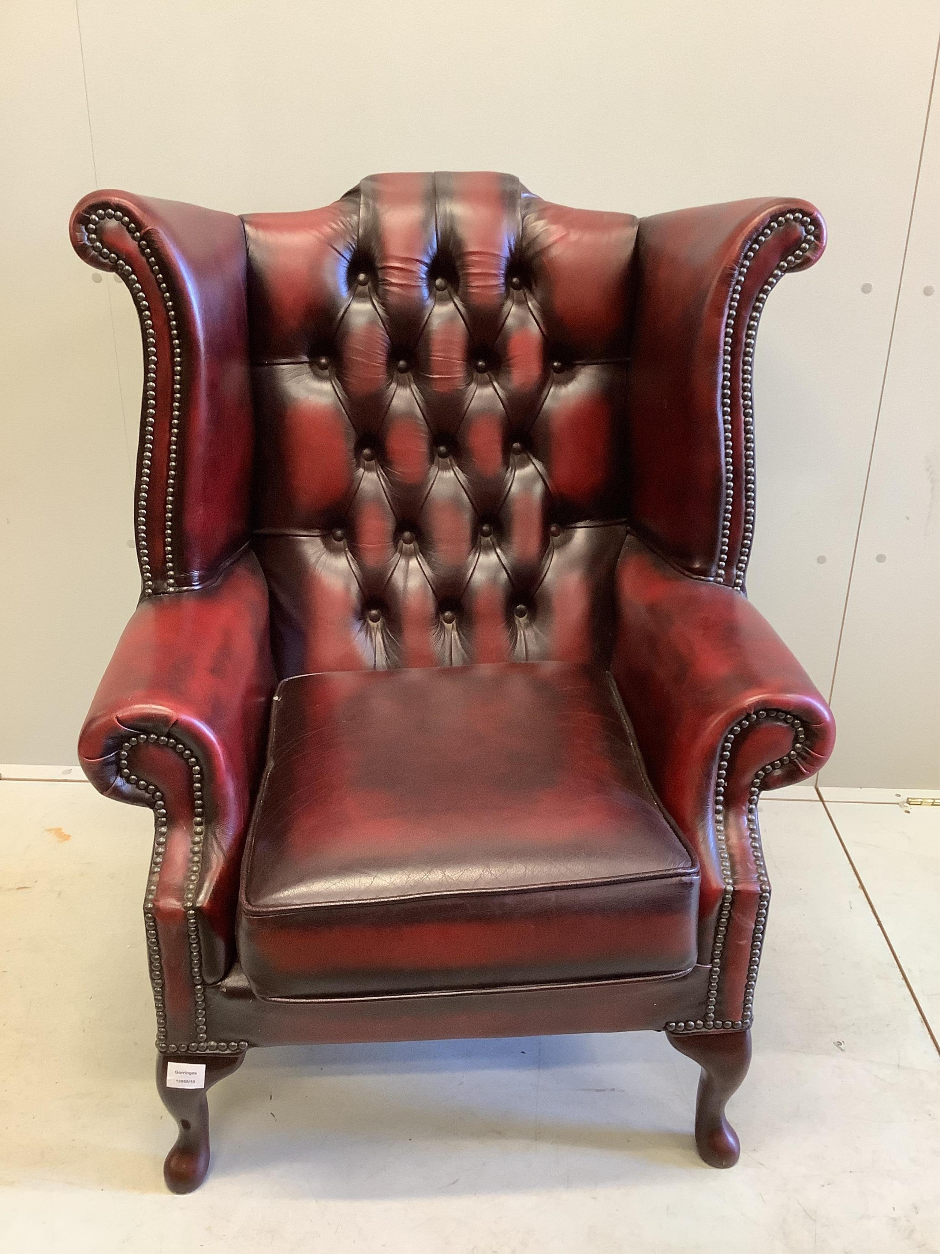 A Victorian style buttoned burgundy leather wing armchair, width 80cm, depth 70cm, height 104cm